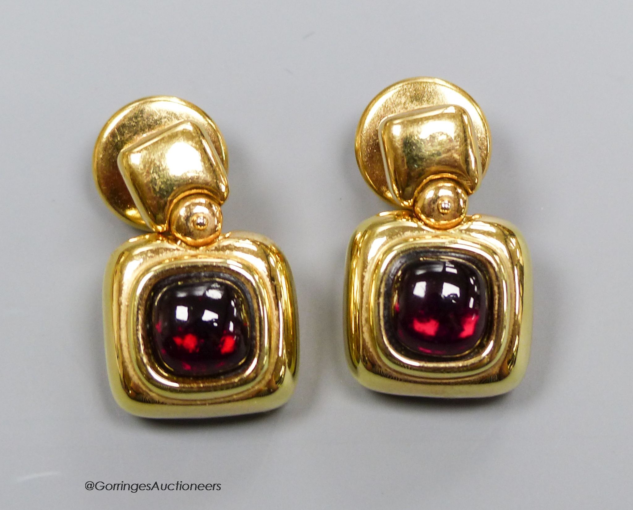 A pair of '750' and cabochon garnet earrings, gross 10g.